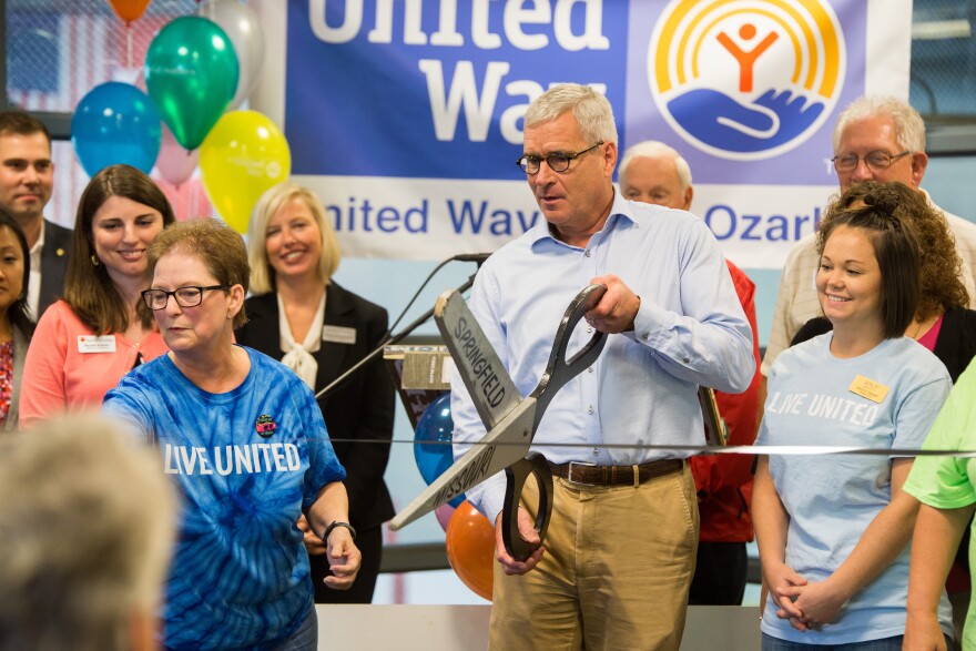 Steve Fox, United Way Campaign Chair, cuts a VHS tap ribbon during the 88th birthday kickoff event at the Mediacom Ice Park on August, 29.