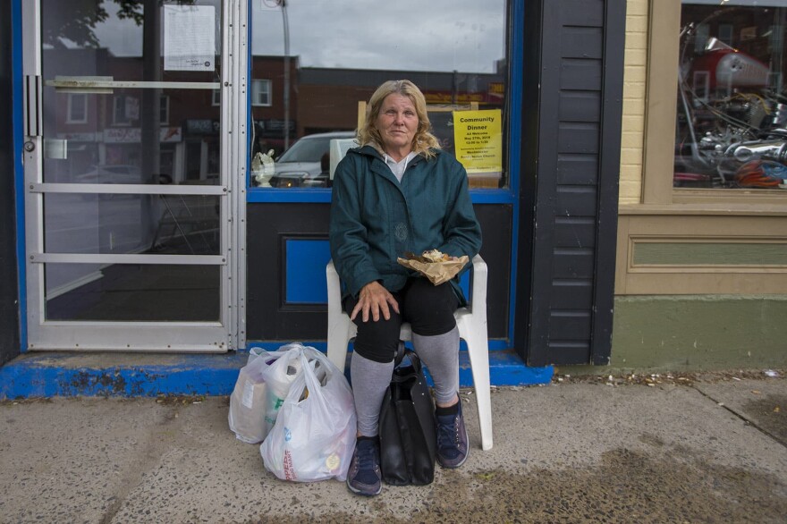 Debra Kimberly Finley sits in a chair in front of the Mission Restaurant in Downtown Smiths Falls. Finley says she has no interest in a marijuana job.
And she says the arrival of Canopy is only reinforcing the town's image as a down-on-it's luck kind of place, "Cause they'll just call it the 'Dope Town.' " (Jesse Costa/WBUR)