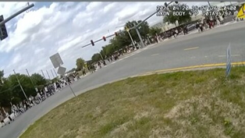 Students leave Windermere High School on e-bikes, weaving through traffic.