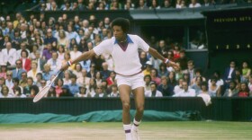 Arthur Ashe runs for the ball during a match at Wimbledon in England. (Photo by Tony Duffy/Getty Images)