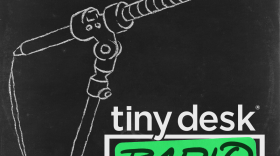 Black background. Sketch resembling a sketch on a chalkboard of a long microphone on a stand. Top left corner: NPR logo. Bottom right corner: tiny desk (white text) radio (dark green text over a lighter green box). White NPR Network logo below that
