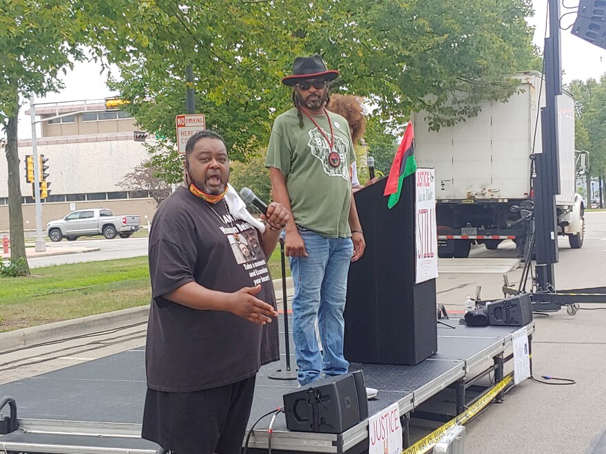 Jacob Blake's father, Jacob Blake, Sr., speaks at the weekend rally, as his brother, Justin Blake, looks on.