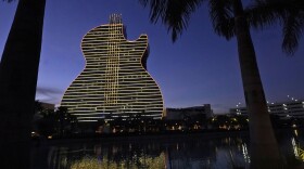 FILE- The Guitar Hotel at Seminole Hard Rock Hotel & Casino Hollywood is illuminated at night in Hollywood, on Jan. 19, 2021.