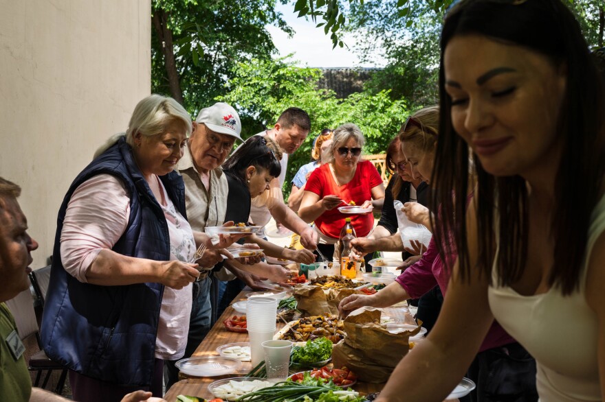 Local volunteers join the mayor (not pictured) of Bilhorod-Dnistrovskyi for an afternoon meal after completing some work, like cleaning up sidewalks and tending to the town's garden beds. Villages in the region are generally small and poor. Soviet monuments still decorate parks. And the area is ethnically varied, with Bulgarian towns, Moldovan, Russian, Ukrainian and others.