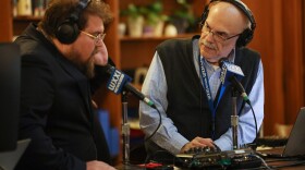 WXXI News Director Randy Gorbman, right, does a live hit with WXXI reporter Gino Fanelli while covering a State of the City event at the Rundel Library in downtown Rochester.