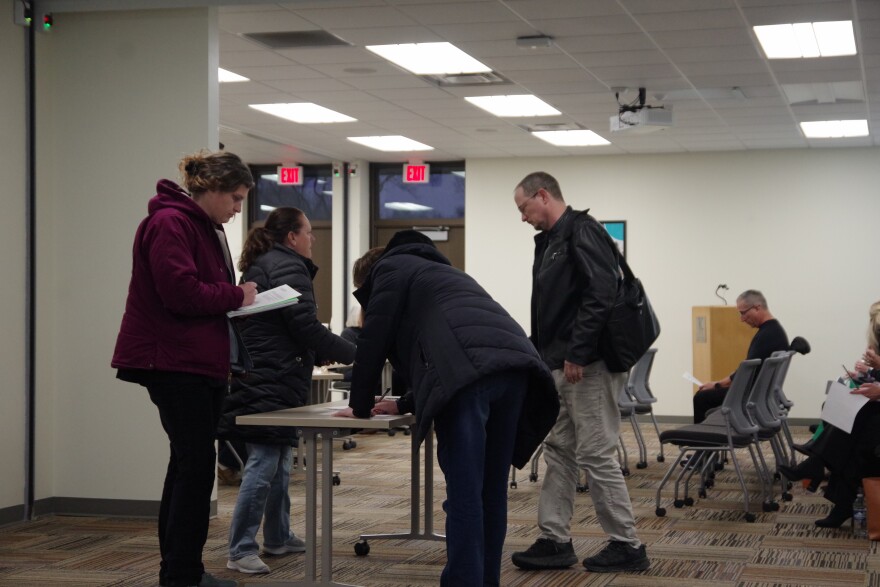 Attendees sign in before the start of Tuesday's KRESA Board of Education meeting.