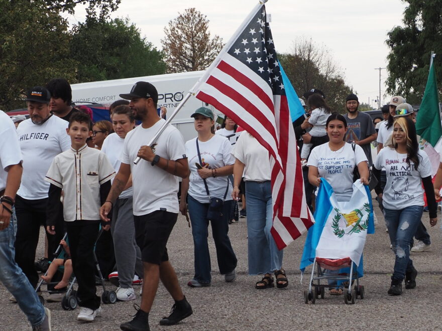  Dodge City protesters gather at Wright Park on Sept. 25, 2026, to march to U.S. Rep. Tracey Mann's office. They were protesting U.S. Immigration and Customs Enforcement actions in the community. 