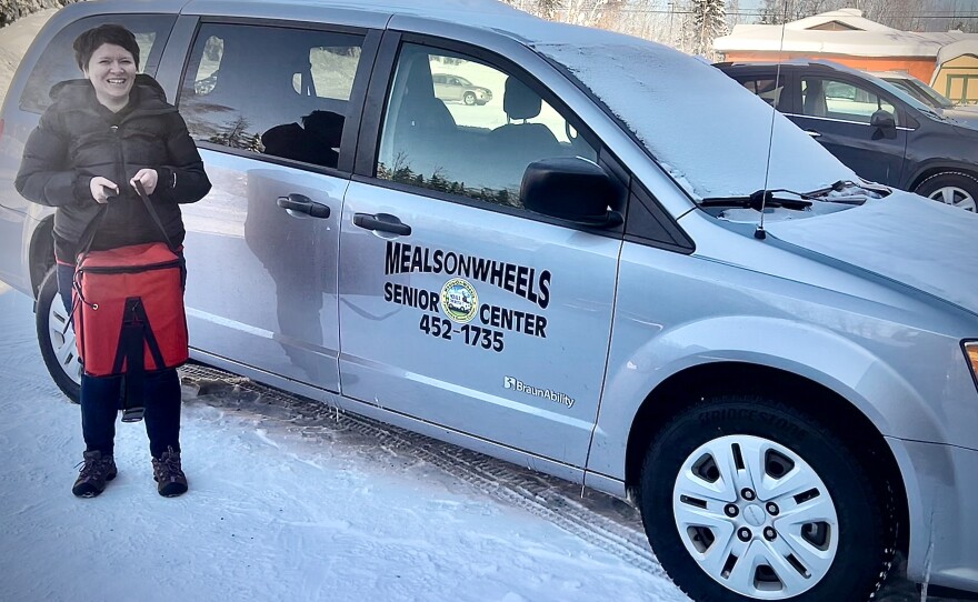Fairbanks Senior Center Meals on Wheels volunteer coordinator Ashley Edginton carries a tote of food for a delivery run March 4, 2026. Edginton's delivery list includes several food-insecure veterans. But as a group, she said, they can be really hard to reach.