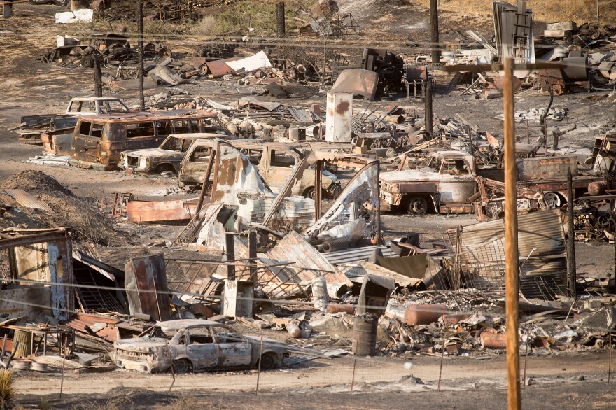 Scorched cars and trailers burned by the Blue Cut fire line a residential street in Phelan, Calif., on Friday.