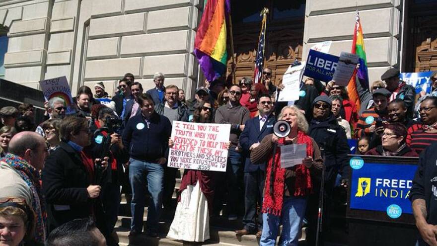 Protesters gather on the steps of the Statehouse during a rally Saturday.