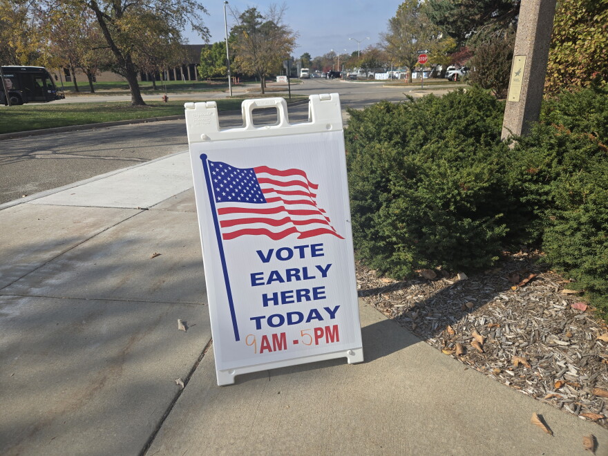 Vote Early Here Today sandwich board sign with an American flag design with a written time of 9 AM to 5 PM