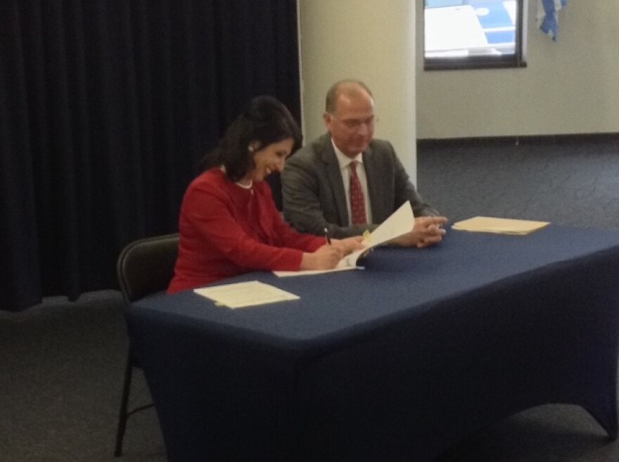 Ceremonial signing of partnership between Monroe County and The Strong