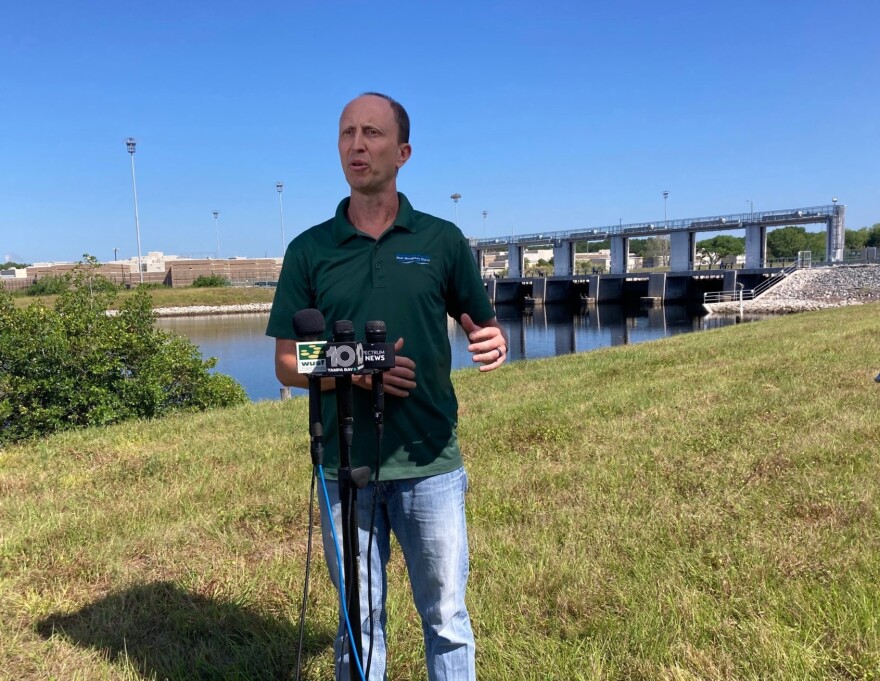 Man in front of water control structure