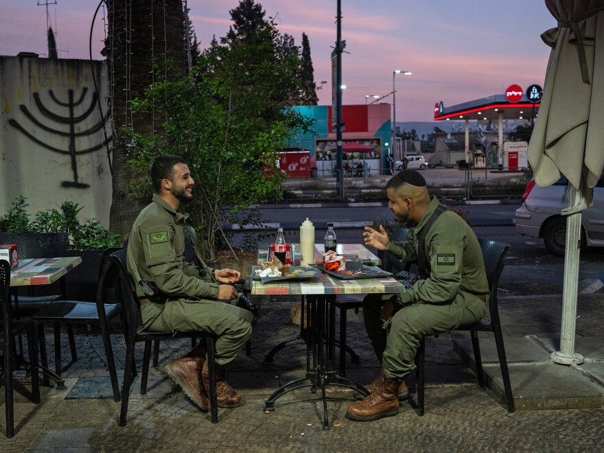 Soldiers eat dinner at a restaurant in Kiryat Shmona, Israel, on Jan. 7. Kiryat Shmona, located approximately a mile from the border with Lebanon, was evacuated as hostilities with Hezbollah escalated following the Oct. 7 attacks.