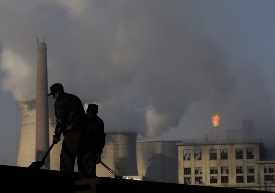 Miners shovel coal at mine in Xiahuayuan county in north China's Hebei province, Friday, Nov. 30, 2007. (Oded Balilty/AP)