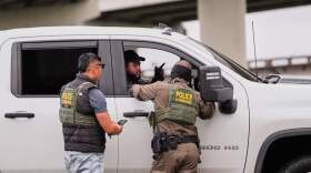 Customs and Border Patrol agents question occupants of a vehicle they pulled over, during an immigration crackdown in Kenner, La., Dec. 5, 2025. (Gerald Herbert/AP)