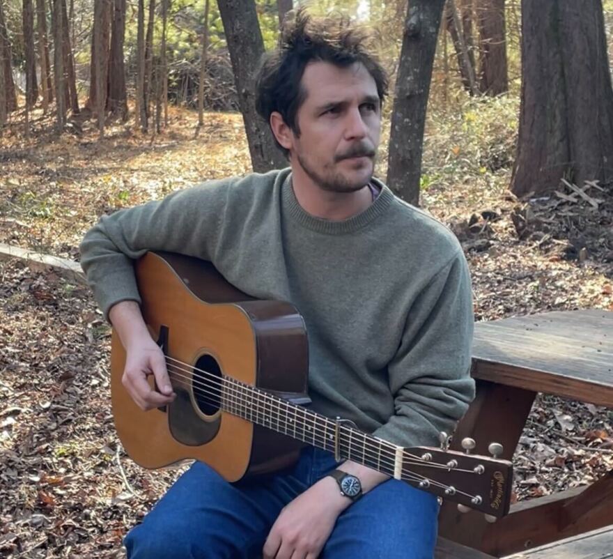 Joseph Terrell holding a guitar