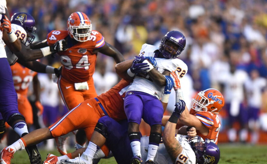 A swarm of Florida defenders bring down East Carolina running back Chris Hairston (22). The Gators held Hairston to just 15-yards on 17 carries.