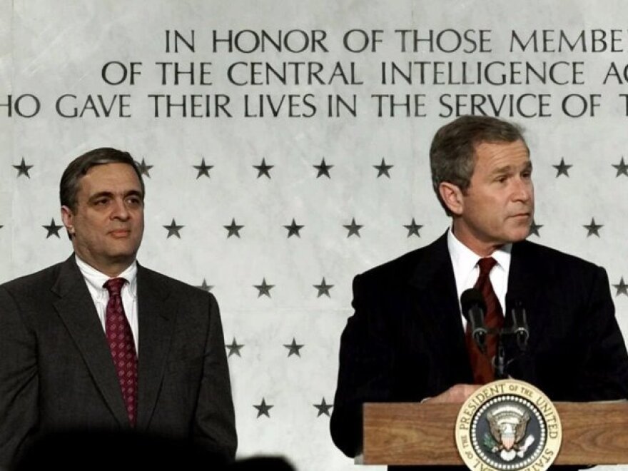 President Bush (right) addresses employees of the Central Intelligence Agency as CIA director George J. Tenet looks on in March 2001.  Under Tenet's leadership, the CIA would develop its role in the war on terrorism after the September 11, 2001, attacks.