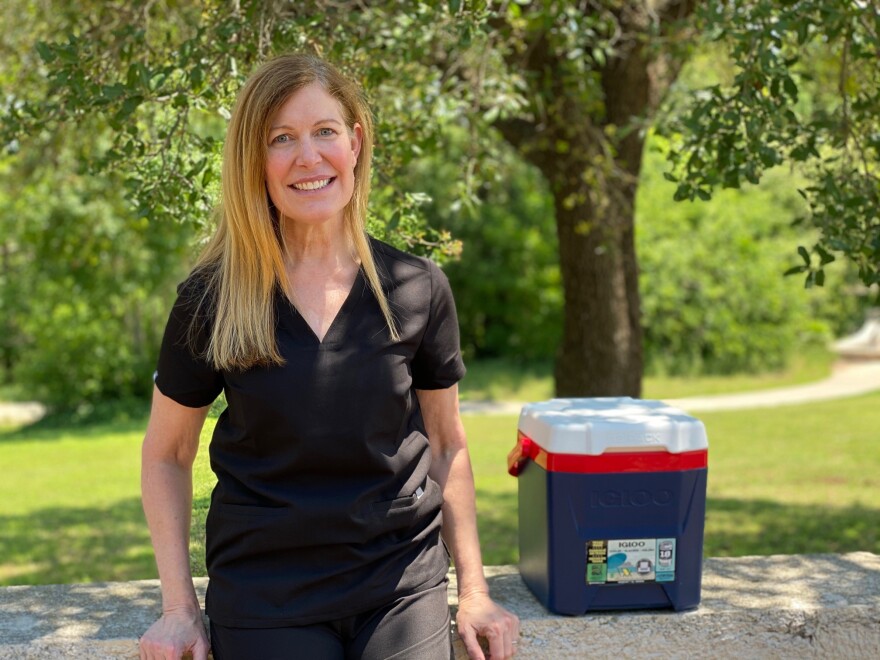 Portrait of Dr. Ronda Mccarthy outside with a cooler next to her.