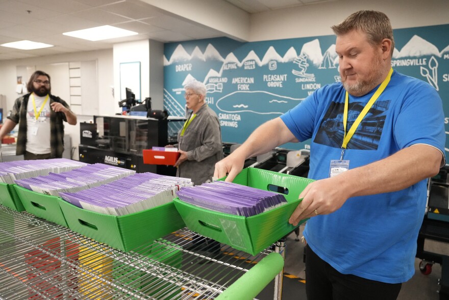 Election workers process ballots at the Utah County Election Headquarters in Provo, Utah, on March 5, 2024.