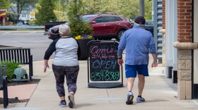 A couple walks in the Rookwood Commons shopping plaza as Ohio businesses reopen in the wake of the COVID-19 pandemic, Tuesday, May 12, 2020.