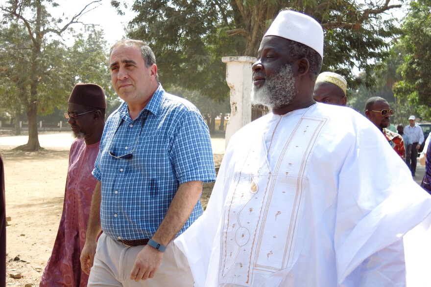 The Grand Imam of Guinea, El Hadj Mamadou Saliou Camara, walks through the streets of Kindia with U.S. Ambassador, Alex Laskaris. Together they hope to end Ebola denial.