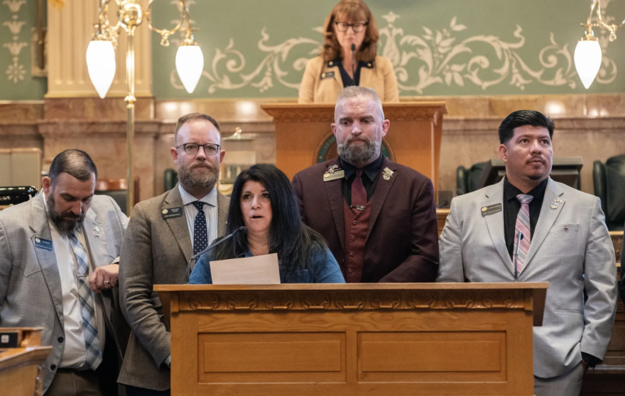 Republican House Minority Leader Rose Pugliese, flanked by fellow Republicans, from left, Ty Winter, Matt Soper, Ryan Armagost, and Carlos Barron, reads aloud a complaint about procedures invoked by the Democratic majority the previous day, on the final day of the legislative session, May 7, 2025.