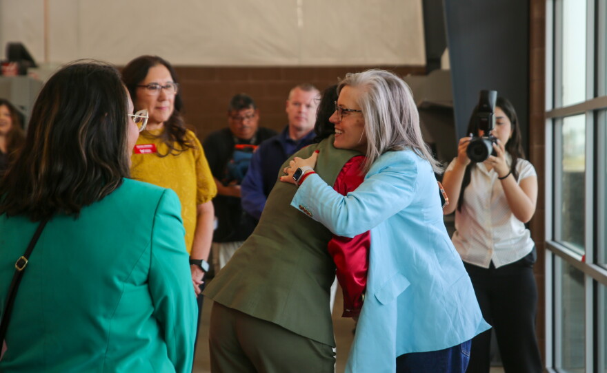 Gov. Hobbs greets AWC President Dr. Reetika Dhawan with a hug.