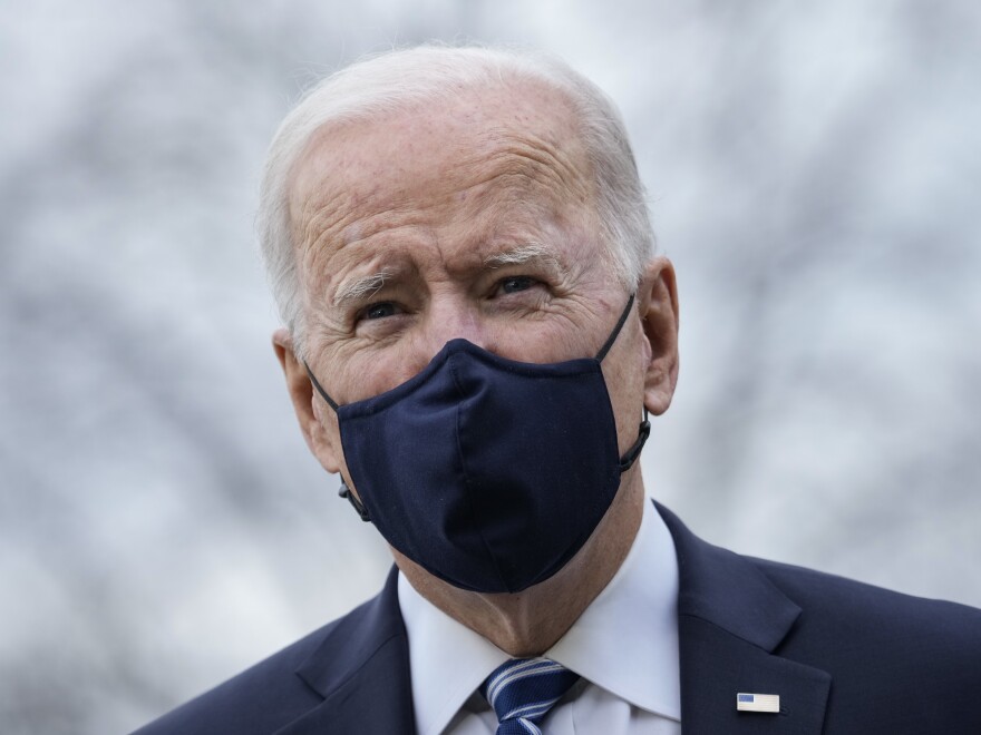 President Biden stops briefly to talk to the press as he walks toward Marine One on March 16.