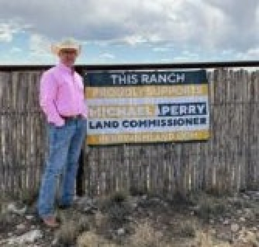 Michael Perry, Republican candidate for New Mexico public land commissioner, stands in front of a sign from a rancher who supports him in an undated photo.