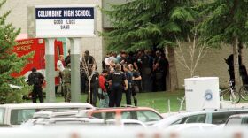 Police gathered at the east entrance of Columbine High School in Littleton, Colo., on April 20, 1999, after two teen students went on a shooting rampage before turning the weapons on themselves.