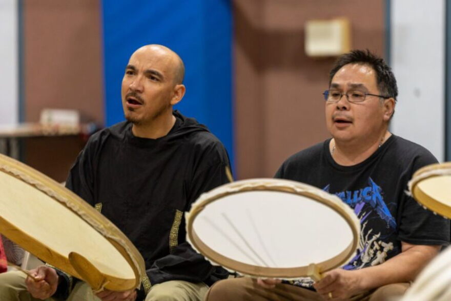 Chris Masters of Uŋalaqłiq Iñuutchak (left) and Robert Tokeinna Jr. of Kingikmiut Dance Group (right) drum together at the 25th Annual Kingikmiut Dance Festival.