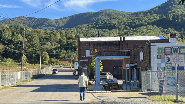 A man walks on Whitson Avenue in Swannanoa Monday. The Buncombe County Board of Commissioners took steps Tuesday to line up money to build, repair and replace sidewalks in Swannanoa’s historic business district.