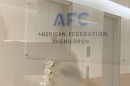 Looking through the locked glass door of the American Federation for Children's office in the Park Cities. AFC's literature says it's based in Dallas, but it files taxes in Maryland.
