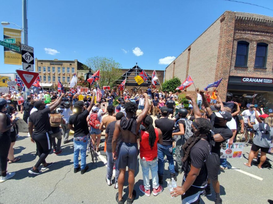 Protesters calling for the removal of Confederate monument in Graham, North Carolina, face off with Confederate sympathizers on Saturday, July 11, 2020.