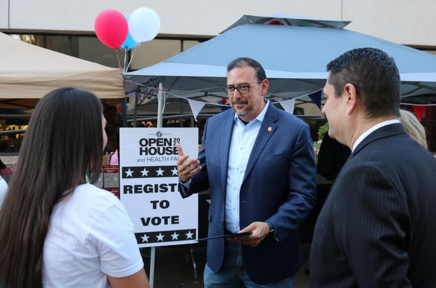 Arizona Secretary of State Adrian Fontes meets in front of NATIVE HEALTH's voter registration booth at this weekend's open house and health fair.
