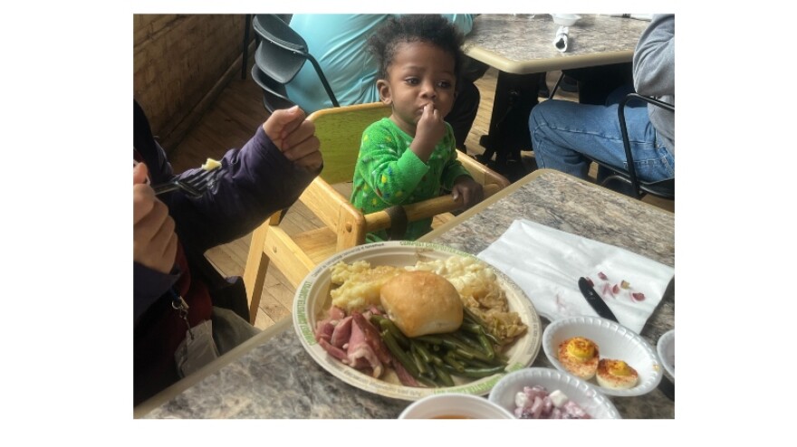 Child enjoying holiday meal at Mel Trotter Ministries