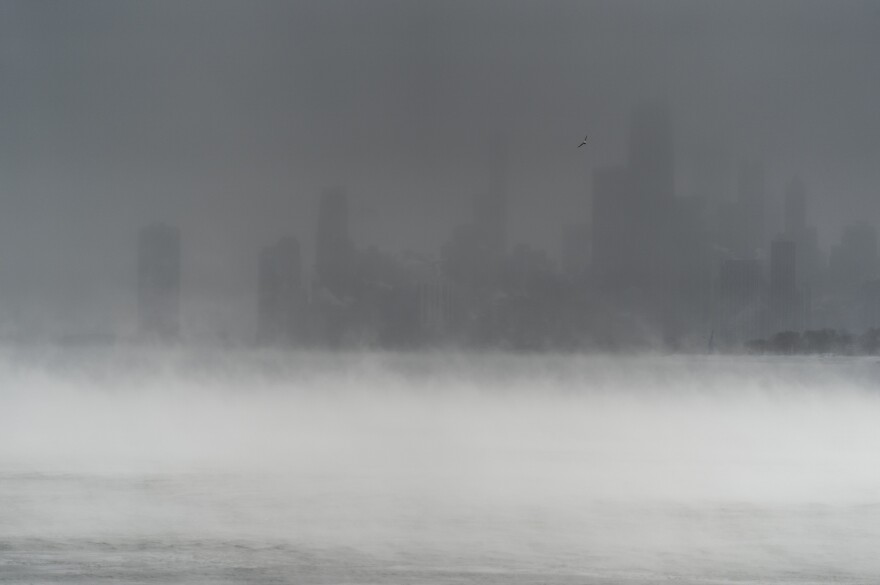The downtown Chicago skyline is obscured by blowing snow and steam rising from Lake Michigan, as seen from Montrose Harbor on Friday, in Chicago.