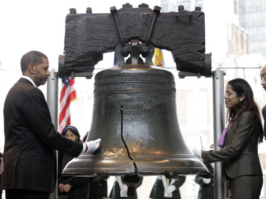 Assistant Secretary for Civil Rights Russlynn Ali and CEO of AmeriHealth Mercy Family Michael Rashid touch the Liberty Bell during a symbolic ringing to mark the observance of Martin Luther King Jr. Day in Philadelphia.