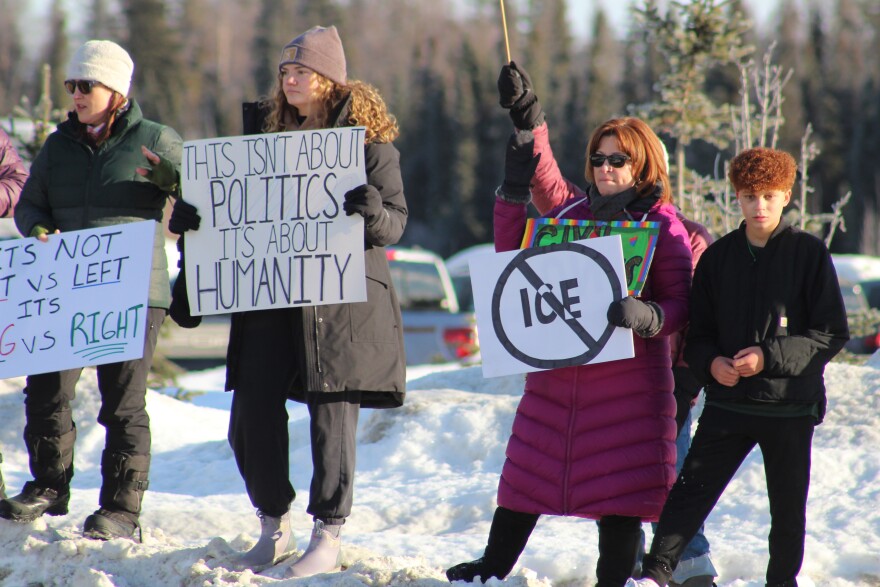 Marianna Macomber holds a sign at the intersection of the Sterling and Kenai Spur highways to protest federal immigration operations on Sunday, Feb. 1, 2026 in Soldotna, Alaska.