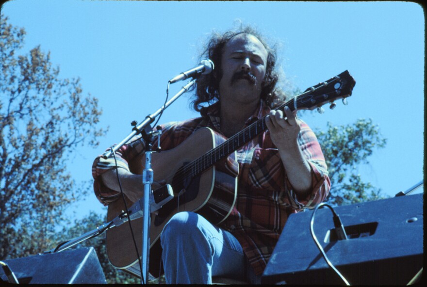 David Crosby playing a guitar.