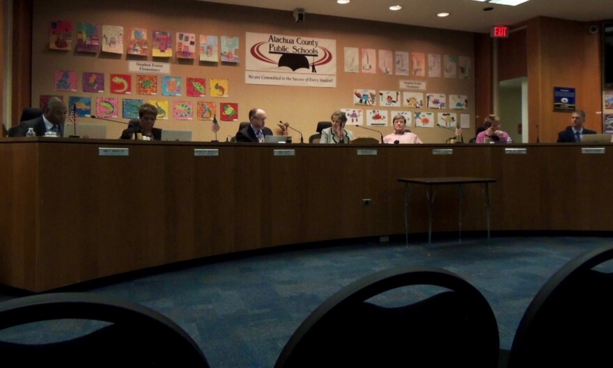 Alachua County School Board members sit in session on Tuesday evening. The board unanimously approved the Connecting Kids to Coverage program, which will help reduce the number of uninsured students and families in Alachua County. That number is currently at 21 percent. photo by Mireillee Lamourt