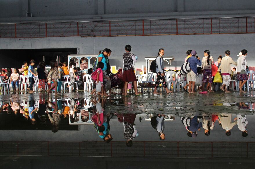 Residents take shelter in a cultural center after Super Typhoon Rai lashed Isabela town of Negros Occidental province on Dec. 17.