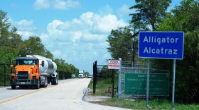 FILE - Trucks come and go from the "Alligator Alcatraz" immigration detention center in the Florida Everglades, Thursday, Aug. 28, 2025, in Collier County, Fla. (AP Photo/Rebecca Blackwell, File)