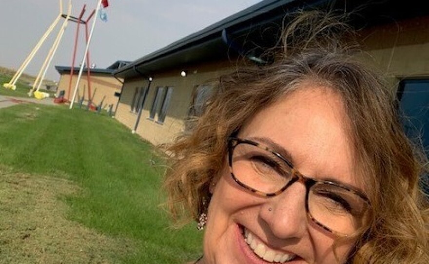 Pam Gunner outside the school she will soon be teaching at on the Pine Ridge Reservation. She feels lucky to have found the job amid the pandemic and has been staving off eviction until she starts getting paid again.