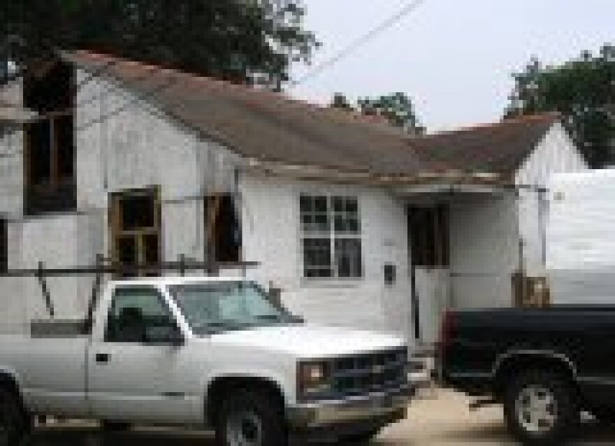 The Wischler's home, protected by plywood as they rebuild.