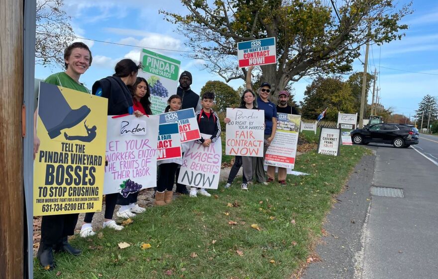 Margaret Palmquist, an organizer with union RWDSU Local 338, leads a protest in 2022 with vineyard workers and their families, calling Pindar Vineyards to the table to negotiate a contract.