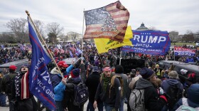FILE - Insurrectionists loyal to President Donald Trump swarm the Capitol, Jan. 6, 2021, in Washington. A college student who posted online that “Infamy is just as good as fame. Either way I end up more known. XOXO” after she climbed through a broken window at the U.S. Capitol on Jan. 6 has been sentenced to a month behind bars for her actions. Gracyn Courtright sobbed as she told Judge Christopher Cooper that “if I could take back anything in my life it would be my actions on Jan. 6.” (AP Photo/Manuel Balce Ceneta, File)