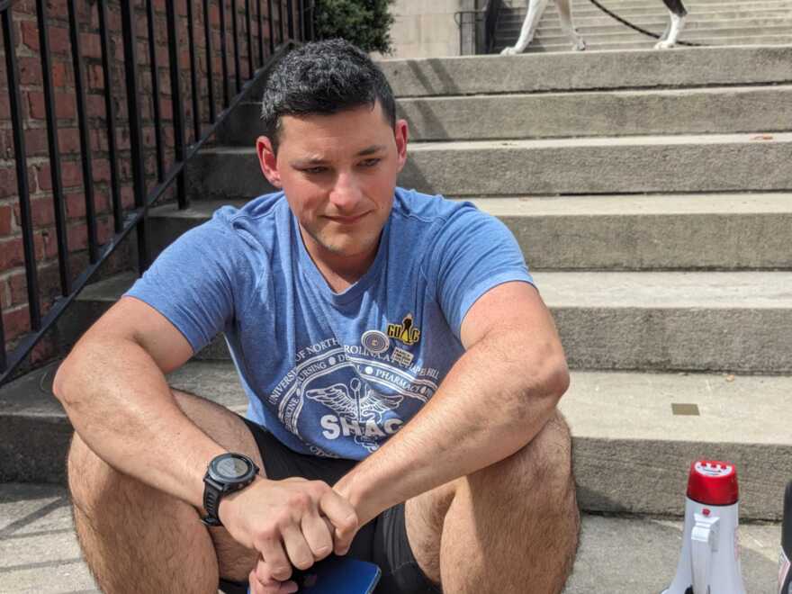 UNC-Chapel Hill medical school student Josh Romero sits on the steps at the UNC-Chapel Hill campus on Sept. 13, 2023, the day an 'armed and dangerous person' alert was issued throughout campus for the second time in 16 days. 